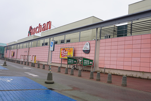 Wroclaw, Poland - October 19, 2023: French supermarket Auchan red logo on top of the shopping centre