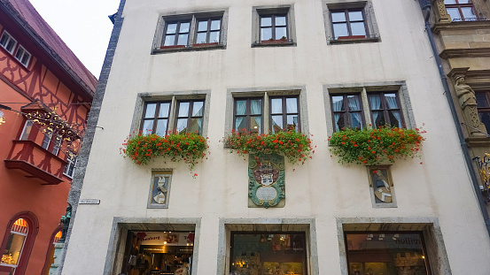 Historical building in Ludwigstrasse of Patenkirchen with history murals. At left side are olympic games, in center is Barbarossa going down on knees in front of King Henry the Lion and at right side is erection of cross on Zugspitze. Down in building are shops