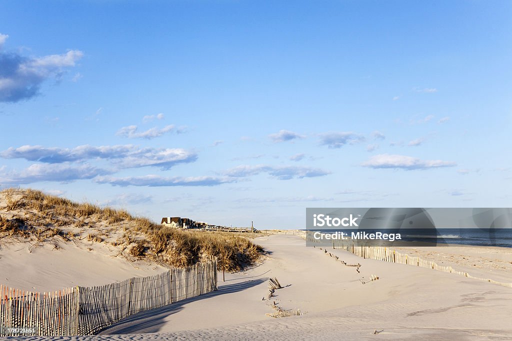 Beach Fence, Sand, Houses and the Ocean. Beach fence, sand houses and the ocean. The fence holds the sands from eroding into the ocean. Cupsoque beach, Westhampton, Long Island, New York. The Hamptons Stock Photo