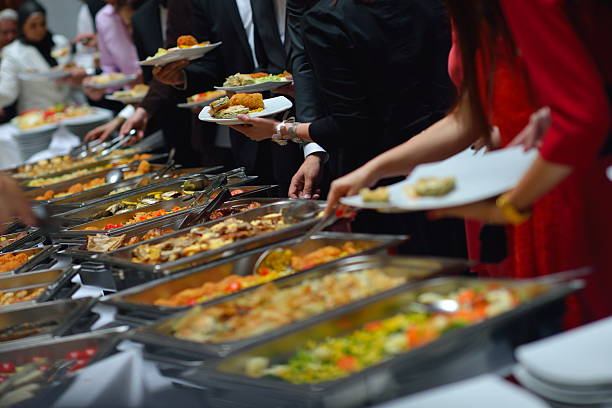 istock A buffet with a number of people serving themselves 178722516