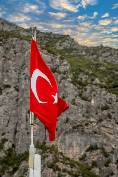 istock Turkish flag. Turkish flag waving in front of rocky background 1787230357