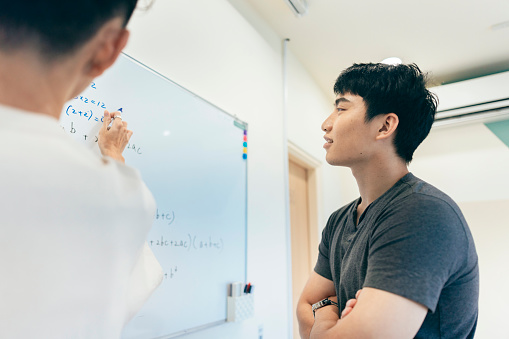 The ambiance in the room is vibrant with intellectual energy, as the students actively participate in the exchange of thoughts, asking questions, and providing thoughtful responses.