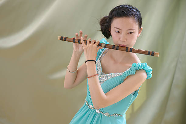 The Chinese girl blowing bamboo flute,bamboo flute is a kind of Chinese music instrument.