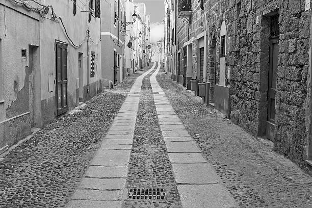 picturesque street in Alghero old town in black and white