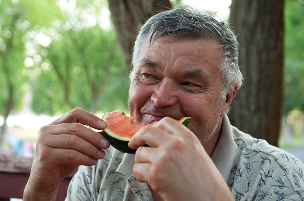 istock Elderly men is eating a watermelon 178725436