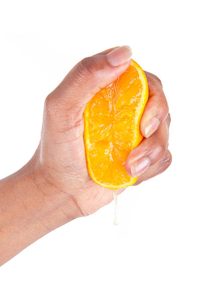 istock African American hand squeezing an orange slice 178727733