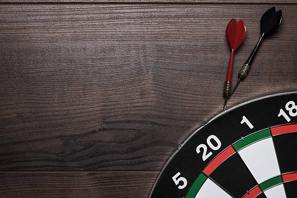 istock target and two darts over brown wooden table background 178727801