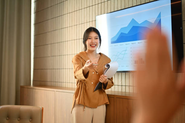 istock Friendly female manager asking question, interacting with team at corporate meeting 1787282598