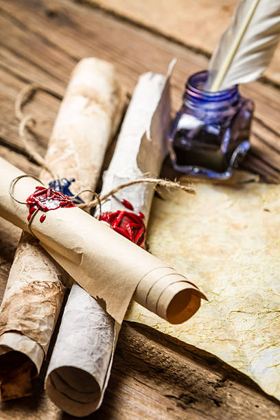 istock Closeup of ancient scrolls writing by feather with blue ink 178728284