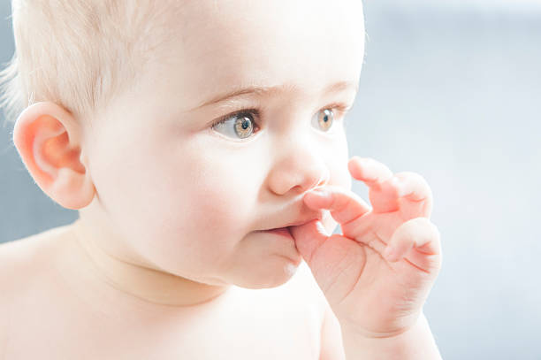 cute baby sucks his thumb