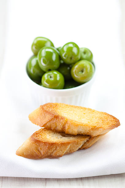 roasted baguette and olives stock photo