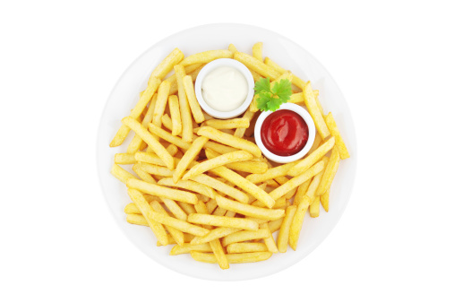 Plate with french fries and sauces viewed from above and isolated on white.