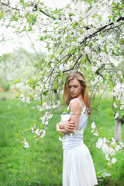 istock beautiful blonde girl in spring garden 178728721