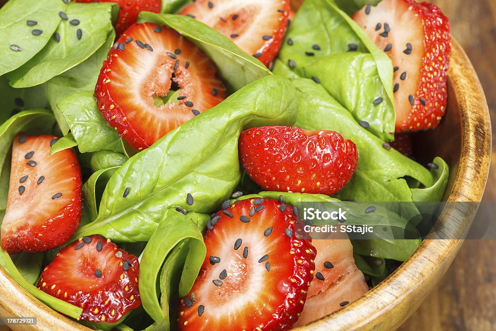 Strawberry Spinach Salad Strawberry Spinach Salad with Poppy seed and sesame dressing. Close up Black Color Stock Photo