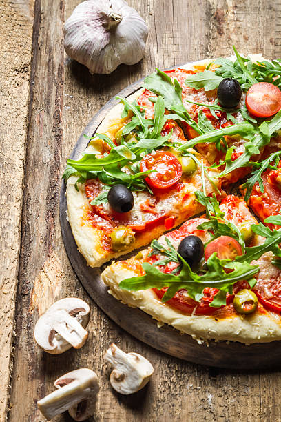 istock Freshly baked pizza on old cutting board 178729492