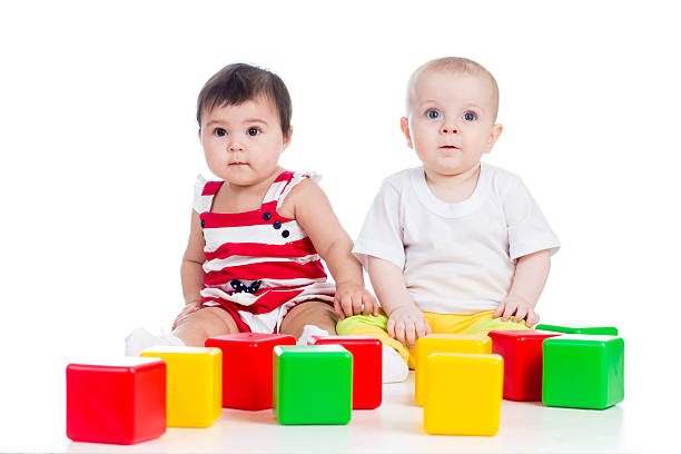 istock two babies or kids playing together with color toys 178729995