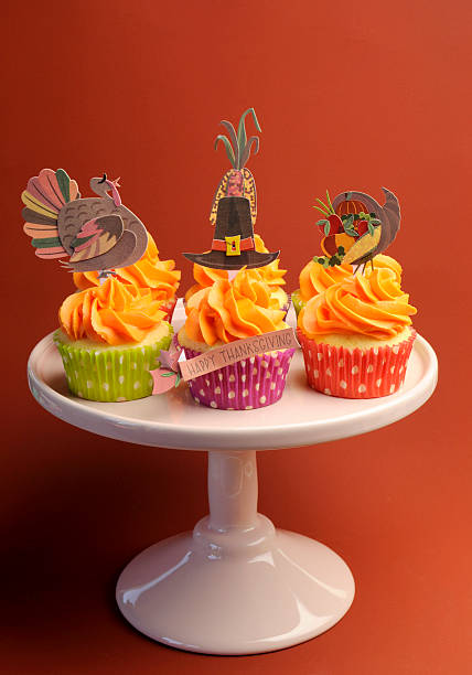 istock Happy Thanksgiving decorated cupcakes on pink stand 178730053