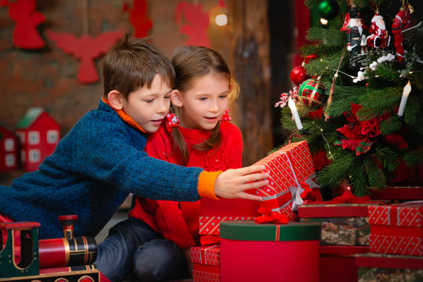 istock Children open Christmas gifts. 1787301551