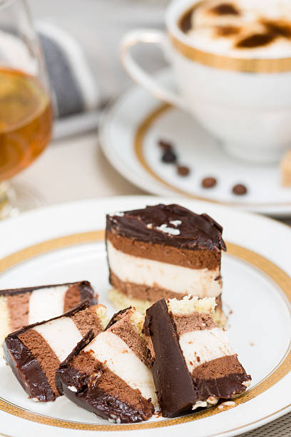 Sliced chocolate cake, cofee and cognac on background stock photo