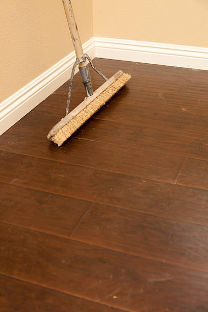 istock Push Broom on a Newly Installed Laminate Floor and Baseboard 178730574