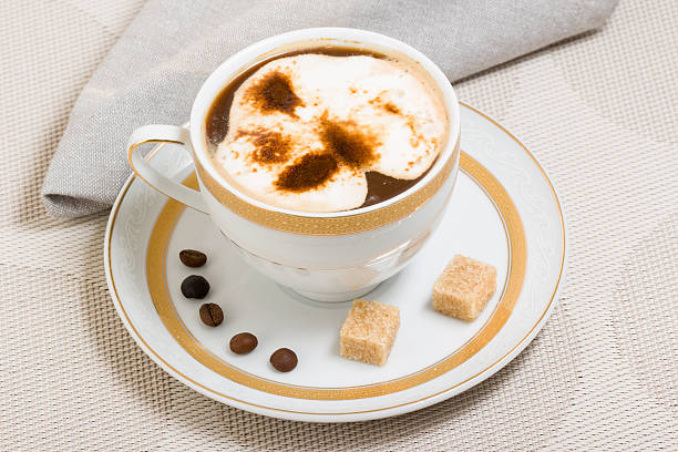 Cup with coffee and two cubes of brown sugar stock photo