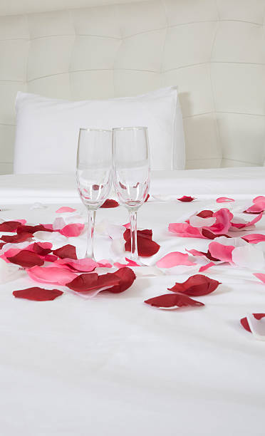 istock hotel room with big bed and red flowers 178730918