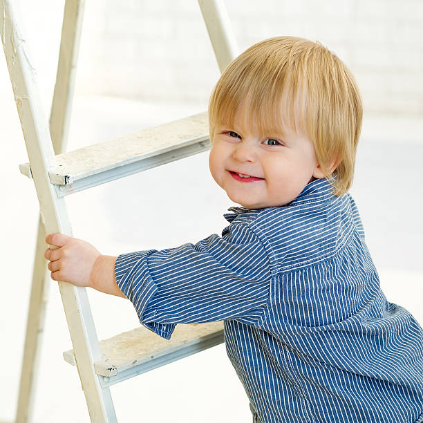 istock Happy little boy climbing the ladder 178731093