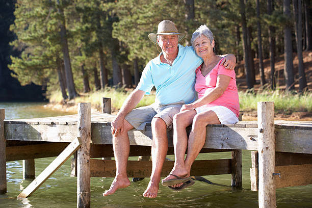 istock Senior couple sitting by lake 178731671