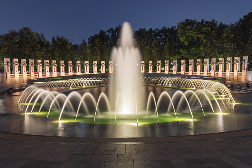 Washington DC, United States - July 27, 2023: Illuminated World War II Memorial at nighttime on the National Mall