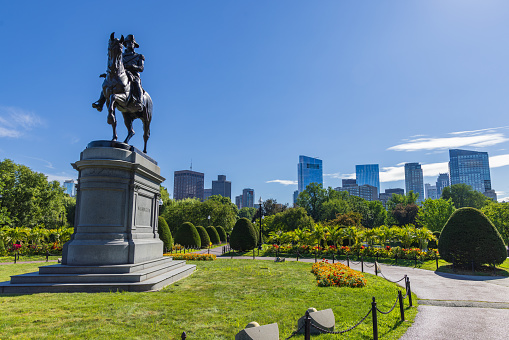 Boston, Massachusetts, United States - August 9, 2023: George Washington statue in the Boston Common park with high-rise buildings in the background. The sculpture was modeled by Thomas Ball in 1864, and cast and dedicated in 1869