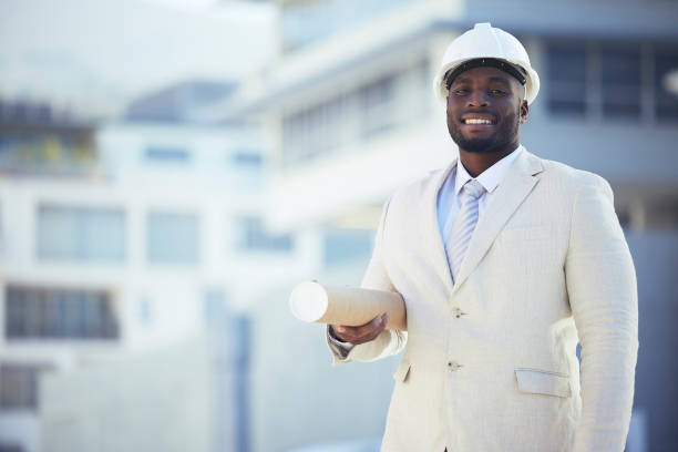 Black man, architect and portrait smile with blueprint for construction, planning or building strategy in the city. African American male contractor smiling with floor plan for architecture on mockup hombre negro, arquitecto y retrato sonríe con un plano para la construcción, la planificación o la estrategia de construcción en la ciudad. contratista masculino afroamericano sonriendo con plano de planta para la arquitectura en maqueta