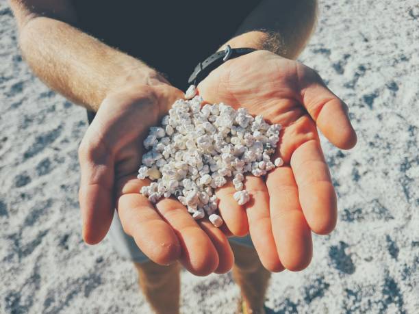 istock Hands full of pebbles popcorn beach 1787322496