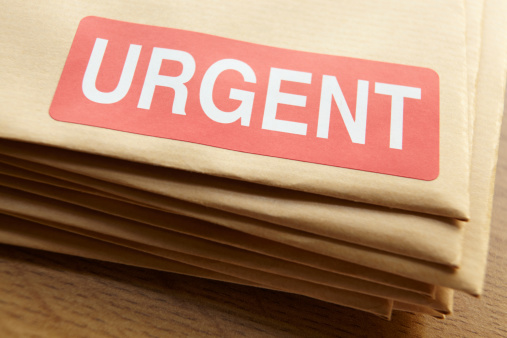 Urgent documents for despatch in a pile on table