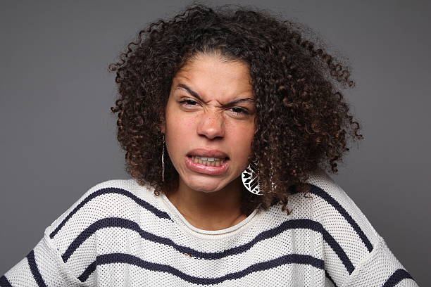 istock Woman with an afro looking angry at the camera 178733478