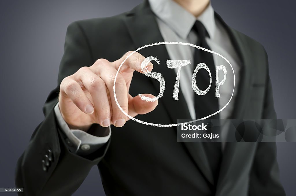 Business man pressing  stop button Business man pressing  stop button on a virtual screen. Adult Stock Photo