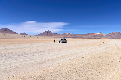 Bolivia, Salvador Dali Desert. Nissan Patrol and a man standing in the middle of the desert. Boliwia, Avoroa Nationa Park,  14.10.2023