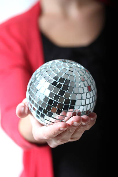 istock girl with a mirror ball in her hand 178734855