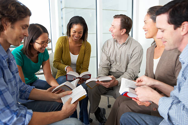 istock Bible group reading together in a close circle 178735011