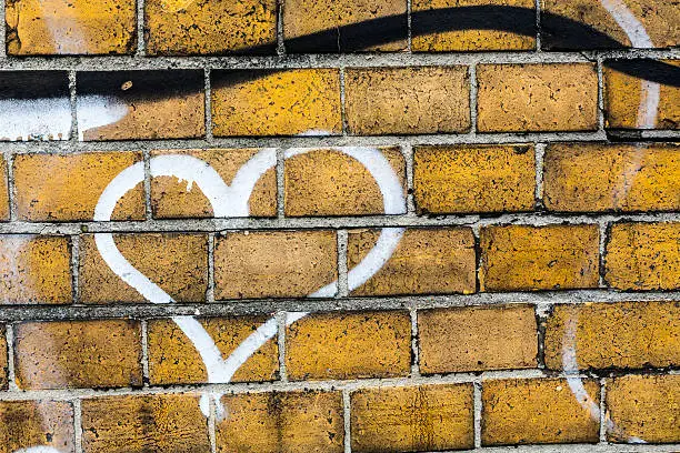 heart graffiti on a brickwall.