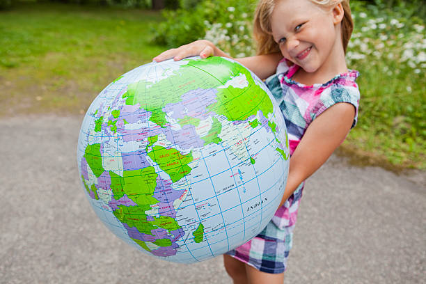 istock Girl holding an earth globe 178735573