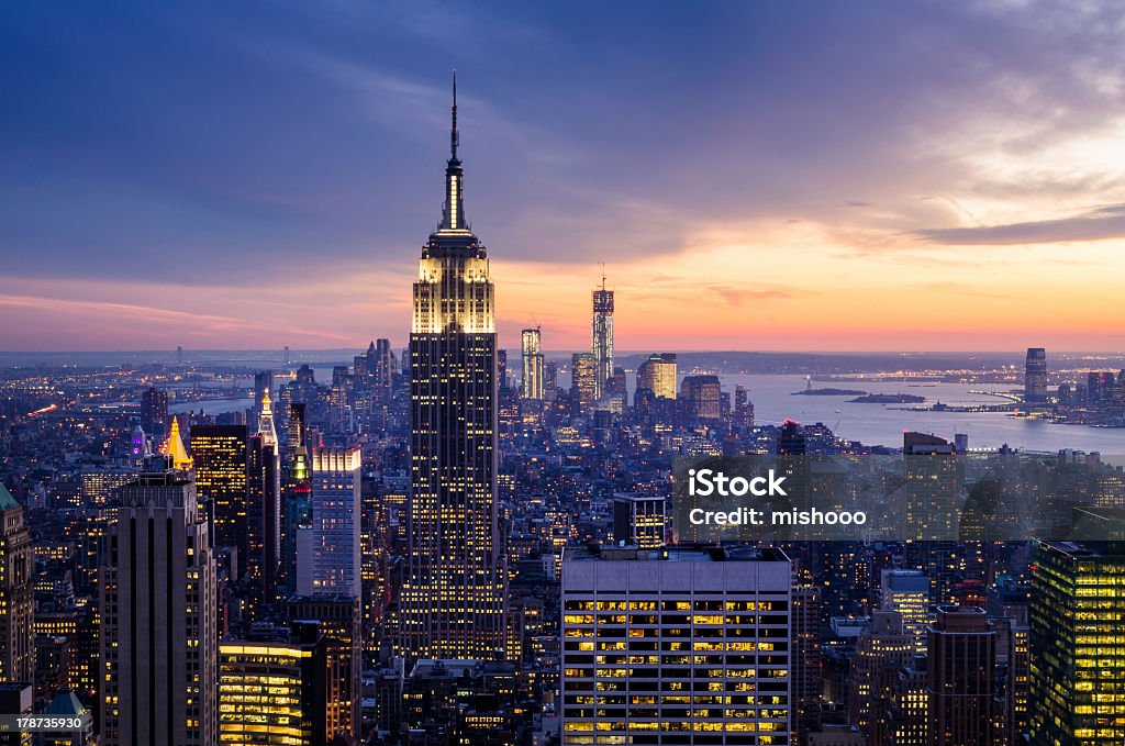 Dramatic sunset view highlighting the Empire State Building New York City with skyscrapers at sunset New York City Stock Photo