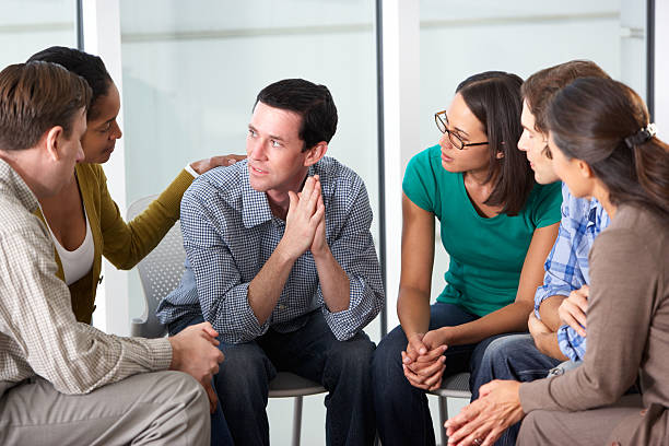 Meeting Of Support Group Meeting Of Support Group Looking At Each Other Talking group therapy photos stock pictures, royalty-free photos & images