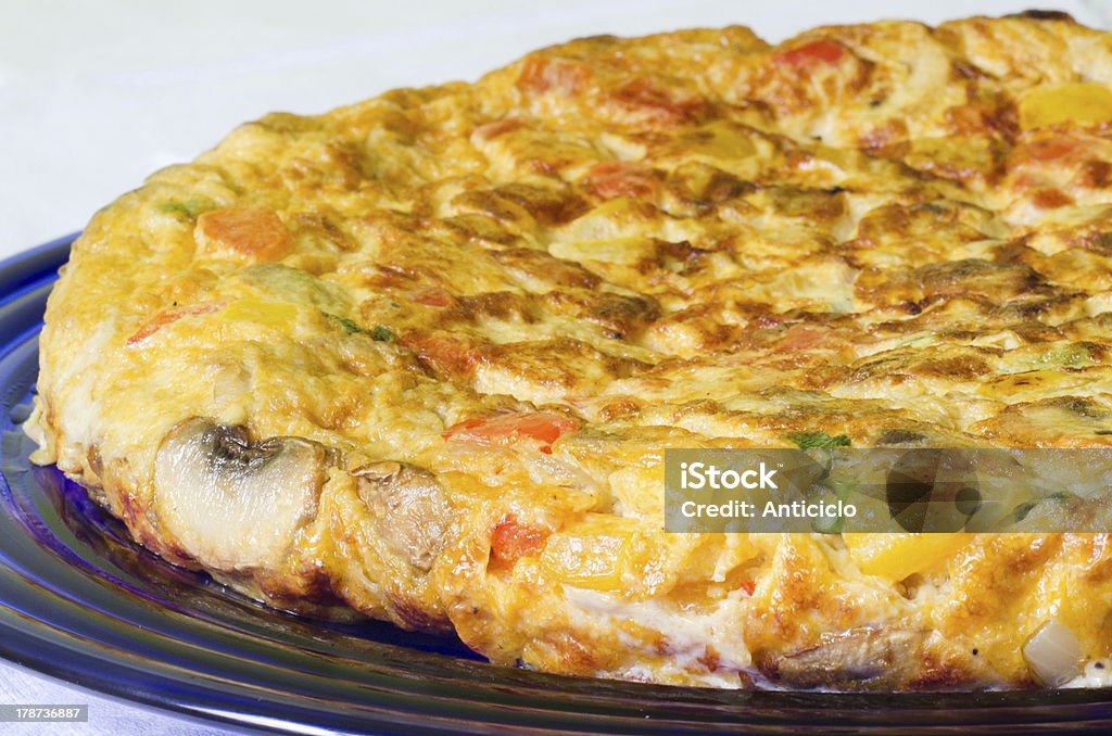 Vegetables omelette View of a big omelette with peppers, potatoes, mushrooms and onion on a blue dish Brunch Stock Photo