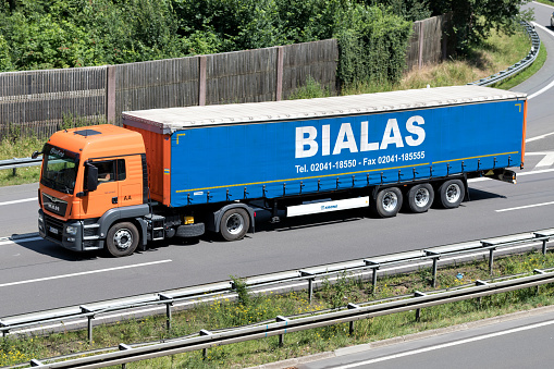 Wiehl, Germany - June 24, 2019: Bialas MAN truck with curtainside trailer on motorway