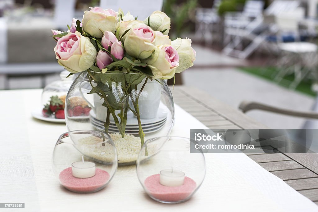 decoration of summer garden table decoration of summer garden table. Roses in vase on white table Arrangement Stock Photo