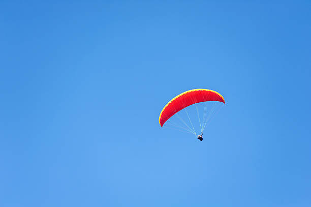 Paragliding in blue sky stock photo