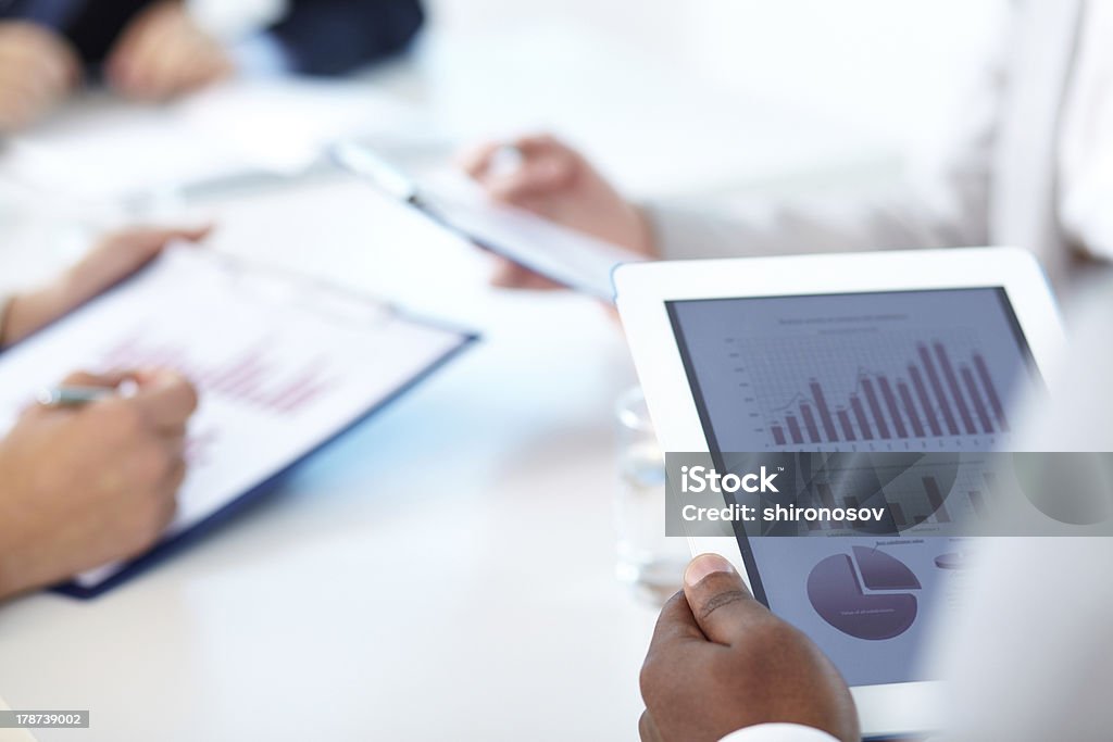 Male hand holding digital tablet Close-up of touchpad in businessman hands Adult Stock Photo