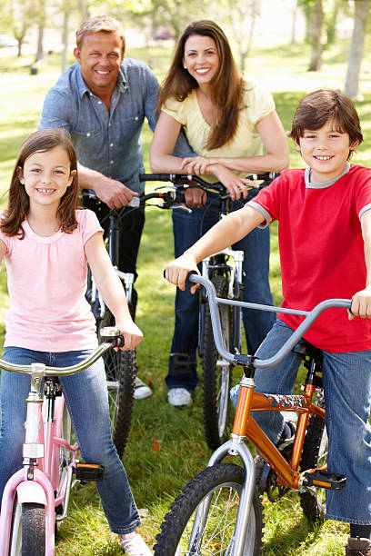 istock Family riding bikes in park 178739092