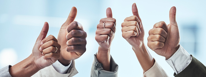 Hands, people and thumbs up for thank you, good job or success in collaboration, agreement or success. Hand of group showing thumb emoji for winning, yes or support in trust, teamwork or solidarity