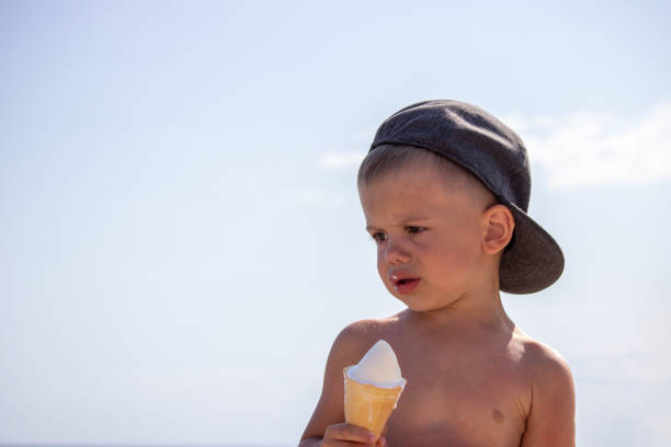 istock little boy eating ice cream on the beach on vacation. 1787397553